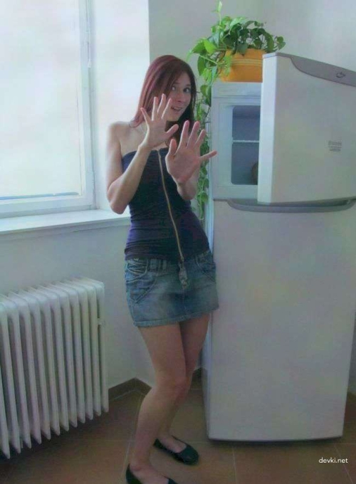 Amateur Girl's Explicit Photoshoot: Seductive Poses and Revealing Outfits by the Fridge