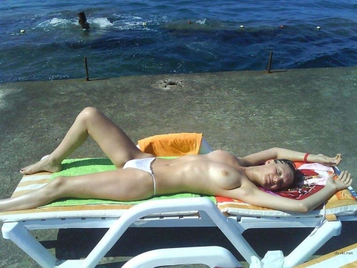 Topless Sunbathing: Amateur Girl's Explicit Vacation Snap